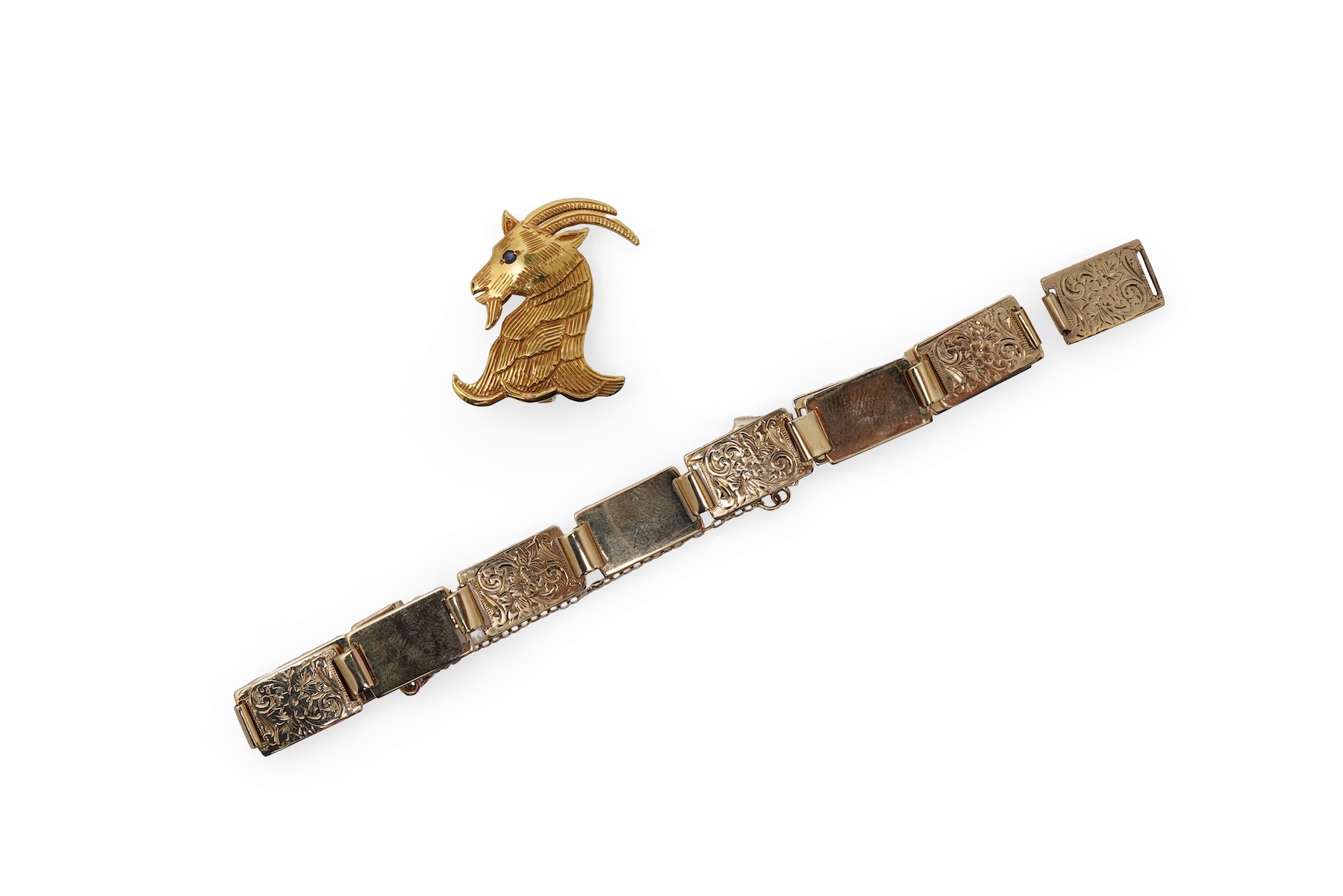 An 18ct gold livery brooch and a gold panel bracelet